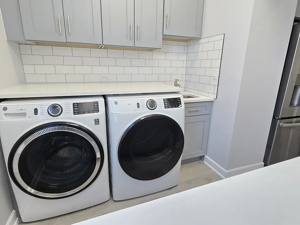 Super convenient in-unit laundry room with cabinets and wash sink, hard to find feature!