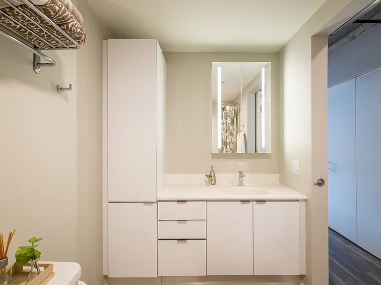 63 E Lake Apartments bathroom in white color scheme
