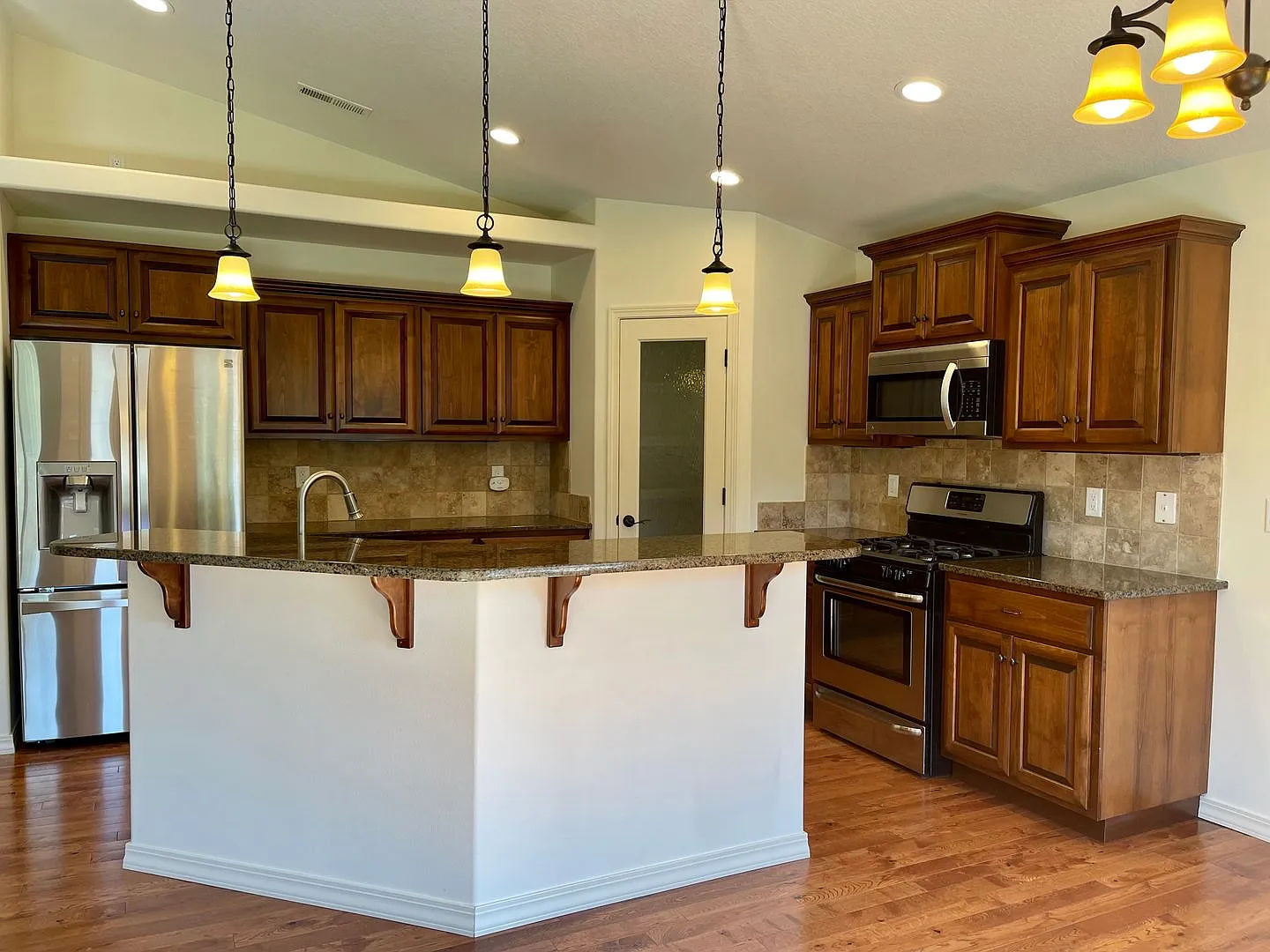 Live In Luxury with Vaulted Ceilings, Granite Countertops, and a Gas Fireplace! — Photo 2