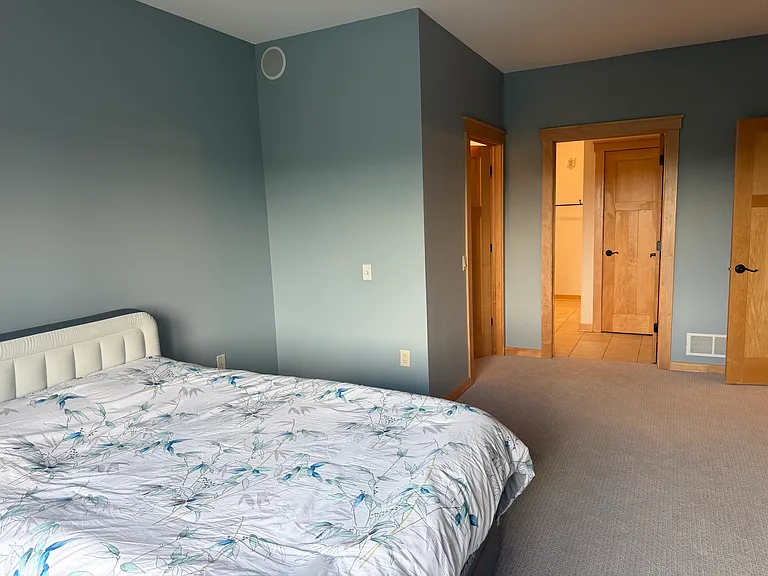Primary bedroom with new light and fan and all new paint through out the condo