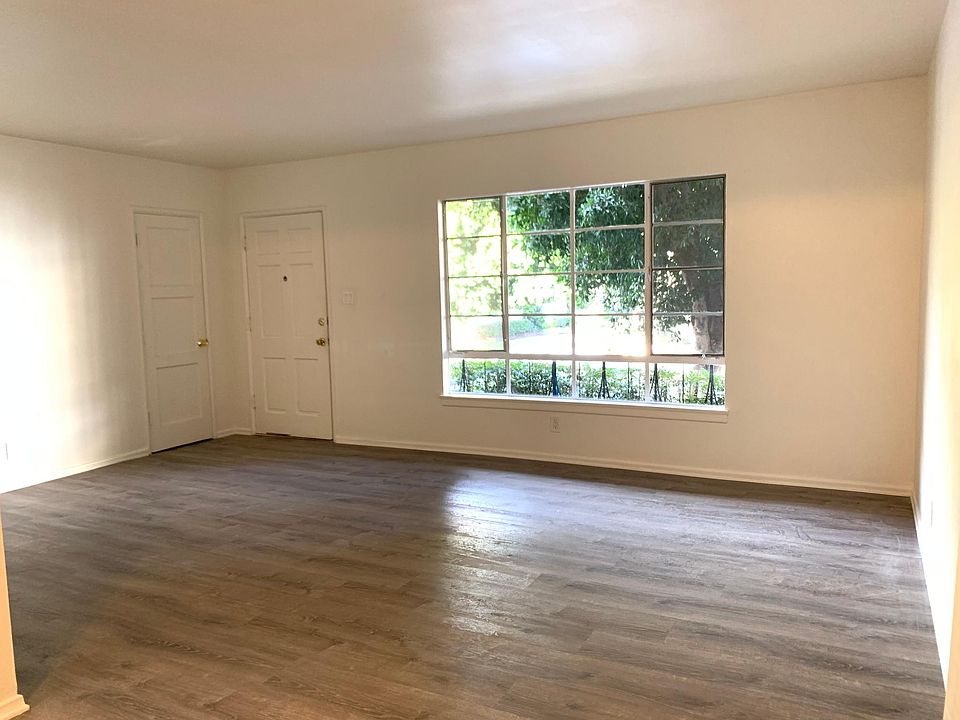 Living room view, storage closet adjacent to front door. Brand new flooring.