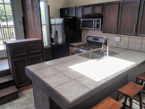 View of kitchen w side by side refrigerator-ice water in door,gas cook stove ,microwave over stove,dishwasher & double bowl sink