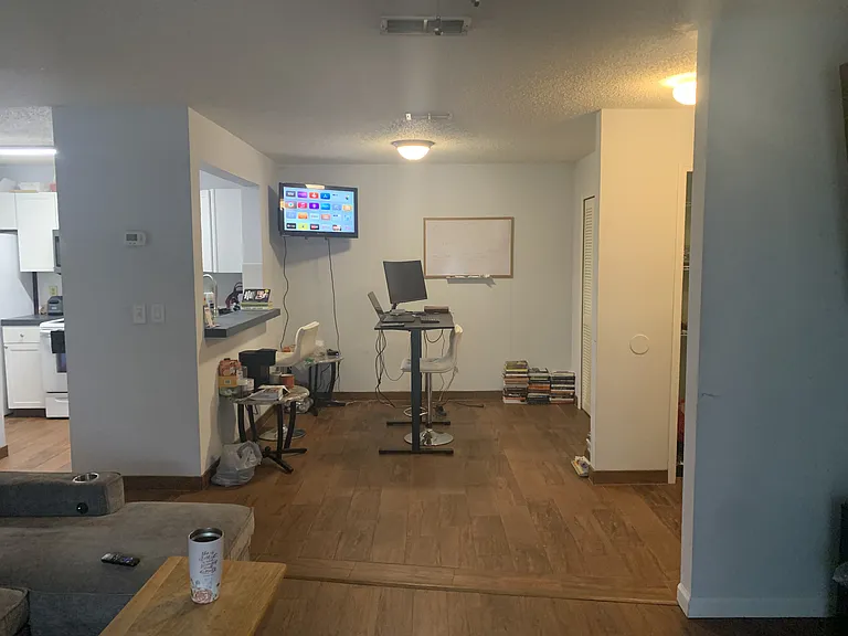 Living room to collab area with standing desk and Apple TV