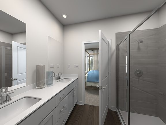 The primary bathroom offers dual vanity sinks and a walk-in closet.