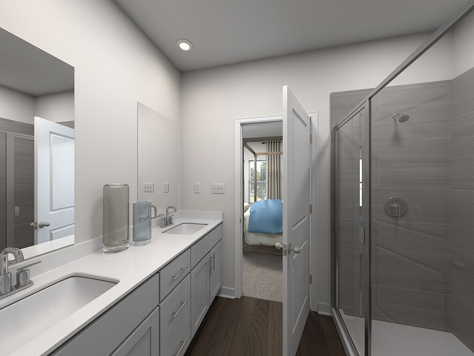 The primary bathroom offers dual vanity sinks and a walk-in closet.