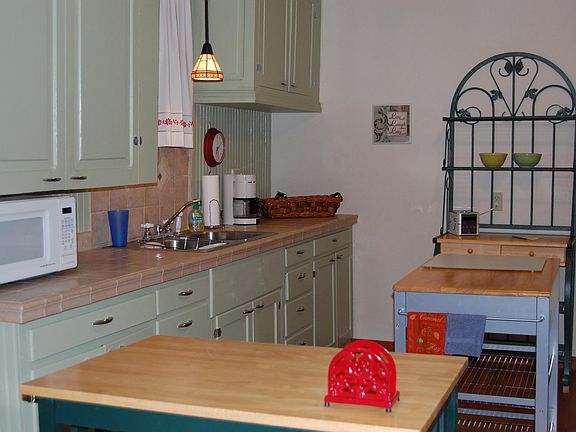 The kitchen includes a wall hutch and a small island.