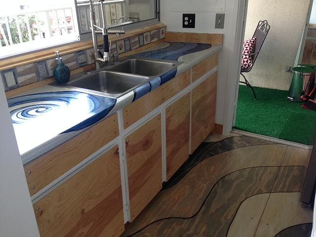 Kitchen opens out to Lanai bar 