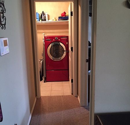 Left of the entry way into the garage entrance and laundry room