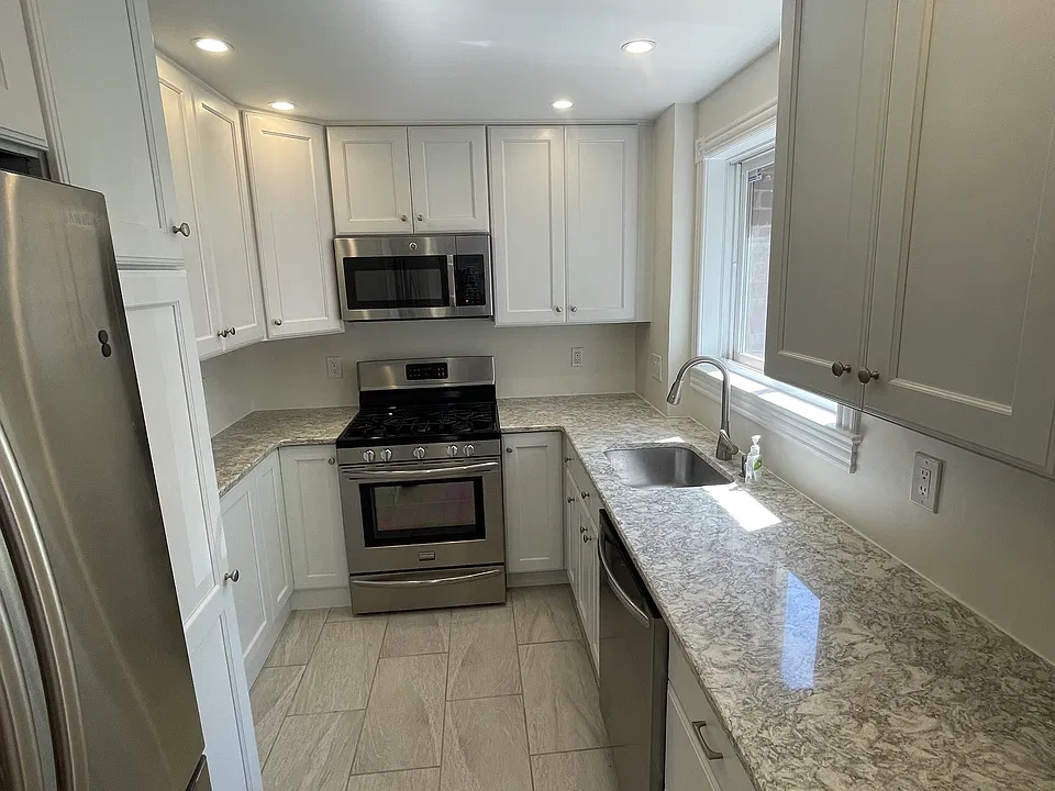 Kitchen has plenty of cabinets for storage and counter space for cooking
