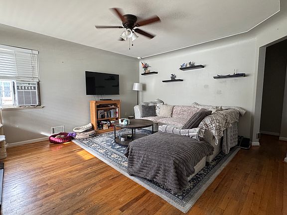 Nice living with corner window providing good light. Ceiling fan and wood floors
