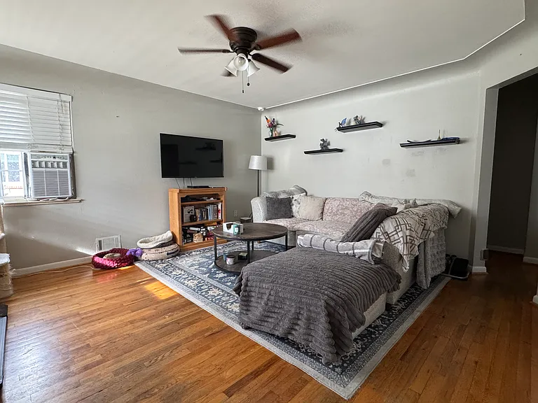 Nice living with corner window providing good light. Ceiling fan and wood floors