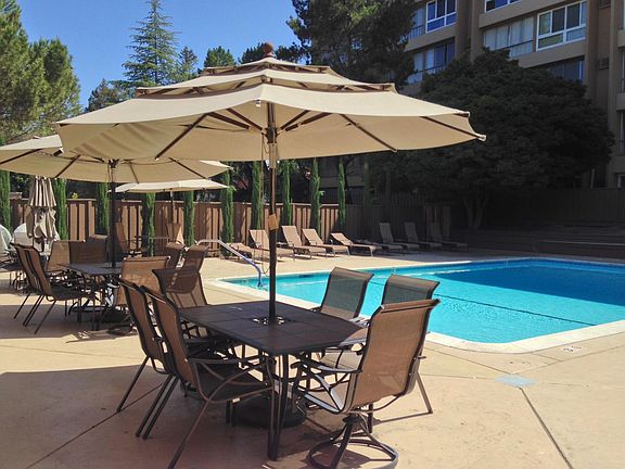 Poolside amenities include lounging and grilling