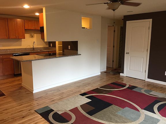 Living room and kitchen. Beautiful hardwood floors. Lots of natural light