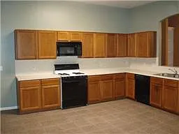 Kitchen has lots of cabinet space and large dining area