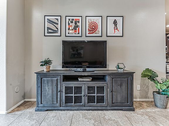 View of TV from couch. Kitchen to right. Master bedroom to left.