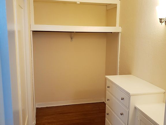Walk in closet with built in dresser and vanity