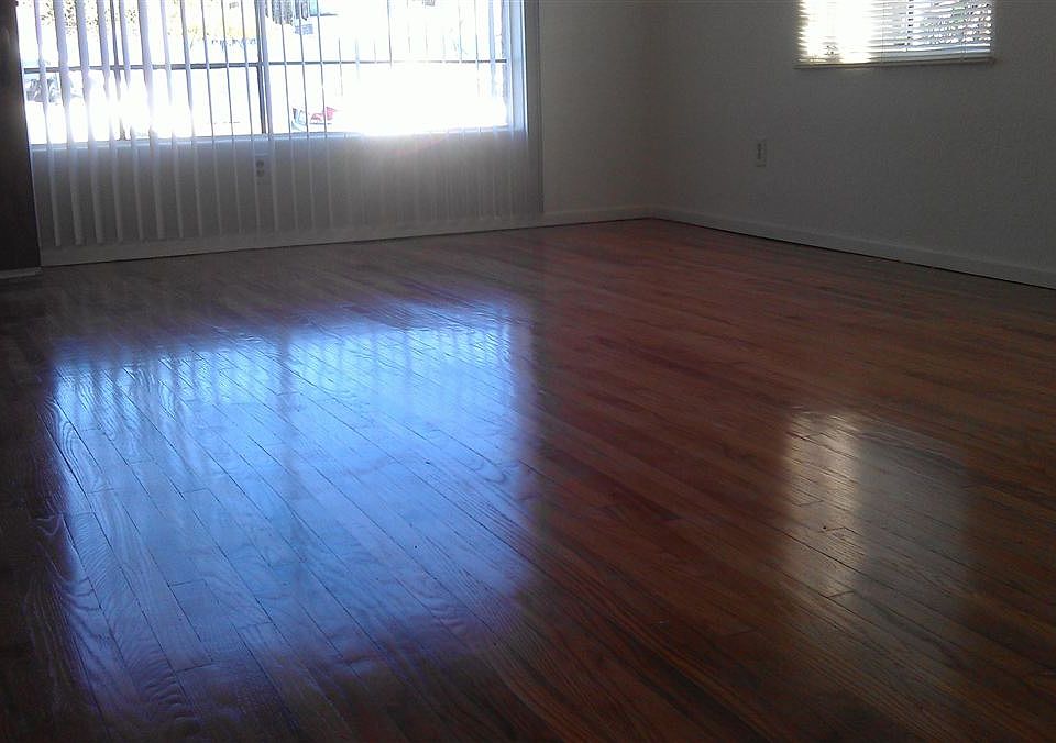 Sparkling wood floors in spacious living room. Lots of windo
