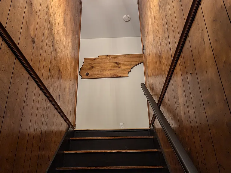 Stairs going up to Bedrooms 2 (Queen Bed and Twin Daybed w/ Pop Up Twin Trundle) and Bedroom 3 (Queen Bed) along with the second bathroom