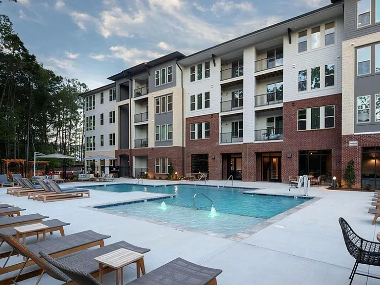 Spacious Pool Deck at Broadstone Trailside with Modern Seating and Ambient Lighting