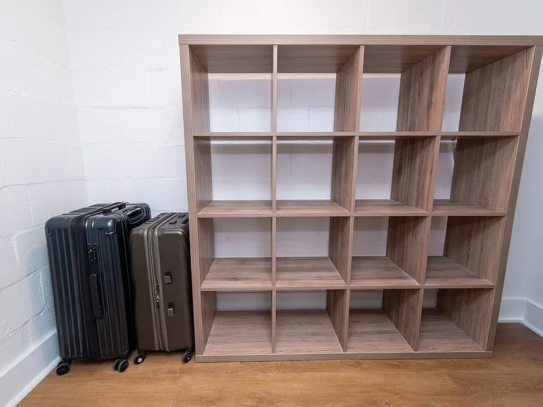 Large multi-purpose storage space with a pocket door for stowing away luggage, bicycles, etc. or use as an oversized pantry.