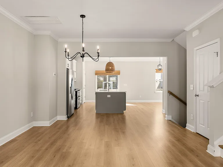 This space can be used as a dining room with the chandelier or create an office on this level