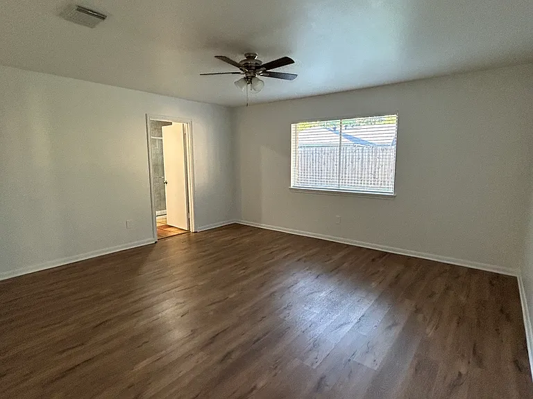 Master Bedroom with view to the backyard and ceiling fan