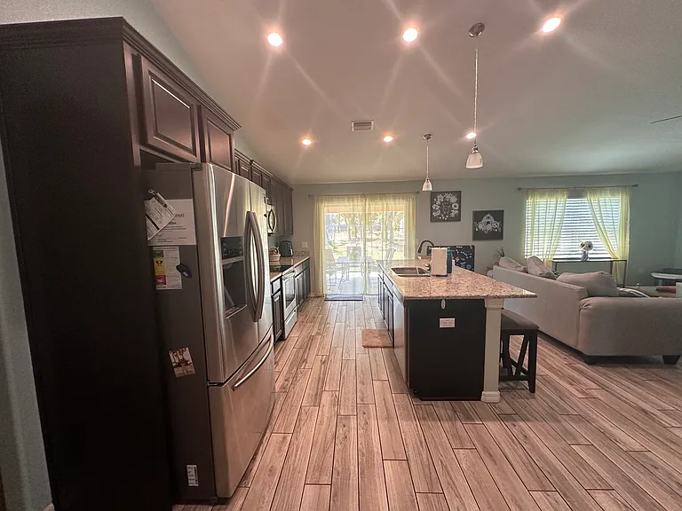 View of kitchen towards covered patio