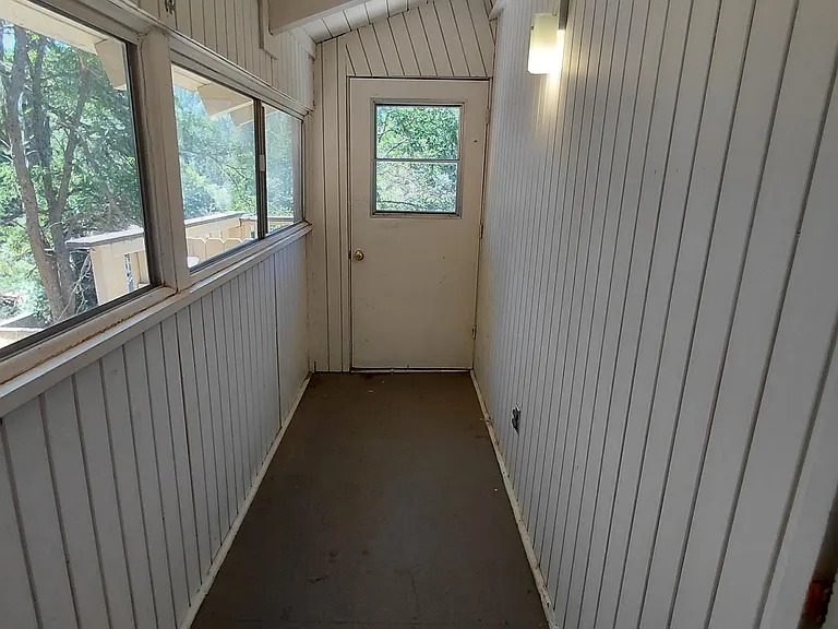Enclosed mudroom/sun porch offering additional storage and flexibility.