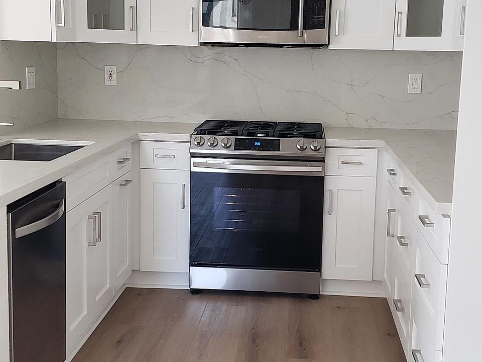Remodeled kitchen with all new cabinets, stove, microwave, Quartz Counter tops, Stainless Steel Sink and hardware/fixtures