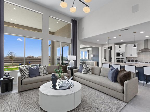 Open living space showing kitchen, dining and gathering room.