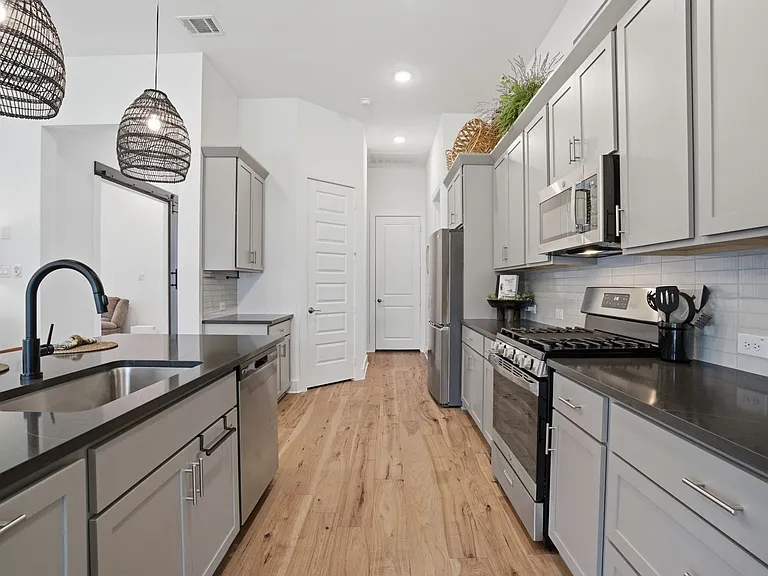 Super clean stainless appliances include a gas range, dishwasher, microwave + includes the refrigerator. Note the corner pantry too.