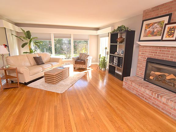 Gorgeous living room with floor to ceiling windows and oak floors