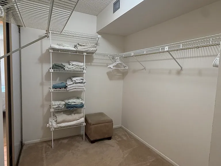 One side of HUGE Primary walk-in closet