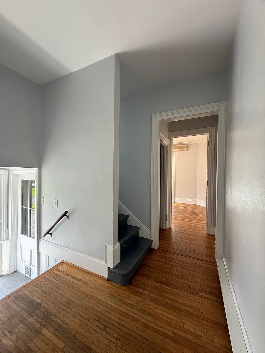 Going left after entering the apartment takes you to the stairs, hallway closet and front room - 106 E Main St #106B
