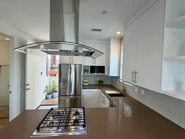 Kitchen with newer stainless steel appliances, gas stove.