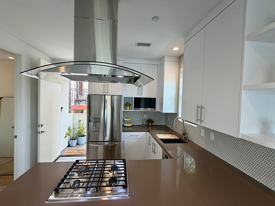 Kitchen with newer stainless steel appliances, gas stove.