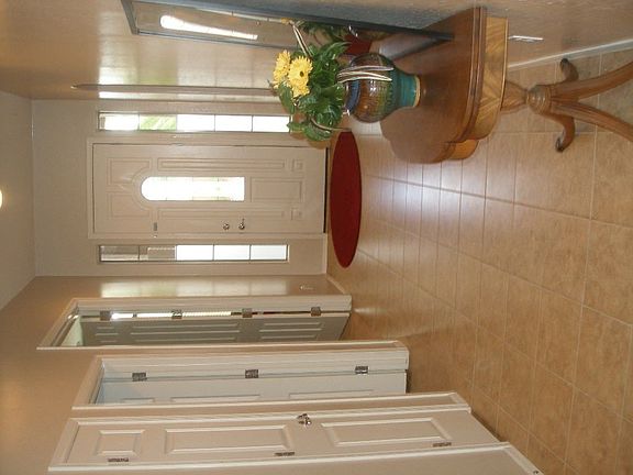 expansivetall ceiling, ceramic tiled hall, kitch and baths