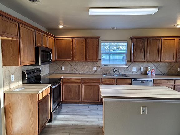 Spacious kitchen with island and stainless steel appliances