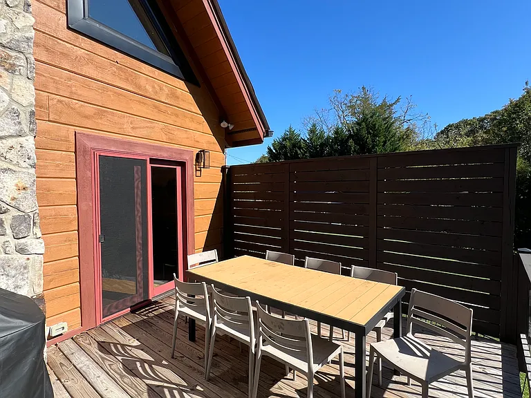 Upper deck off of the family room. Includes outdoor table and chairs and propane grill.