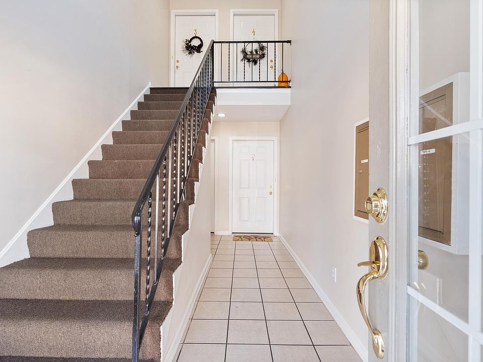 Entrance - unit is on bottom floor to left behind staircase -- not steps to enter from the front.