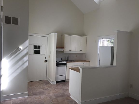 View of kitchen & entry door from living room