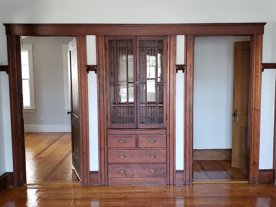 Built in cabinet in dining room. Bedroom 2 door on left and hallway door on right.