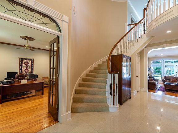 As you enter, you notice the graceful millwork and views of the park-like backyard. French doors open to the study to your left.