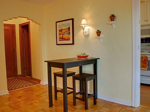 One potential dining area with foyer in background - there is room for a much larger dining table.