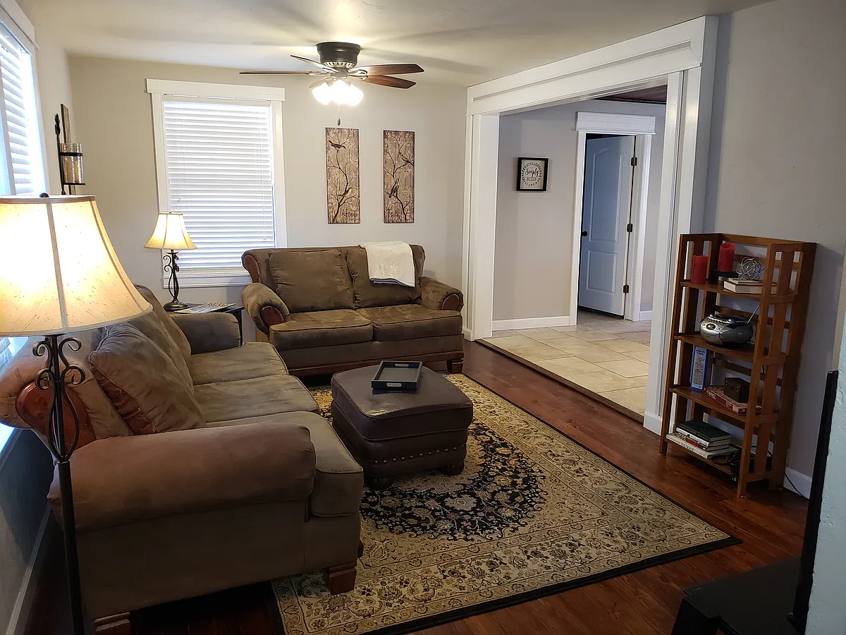Living room with refinished original hardwood floors. - 922 N Muskogee Ave
