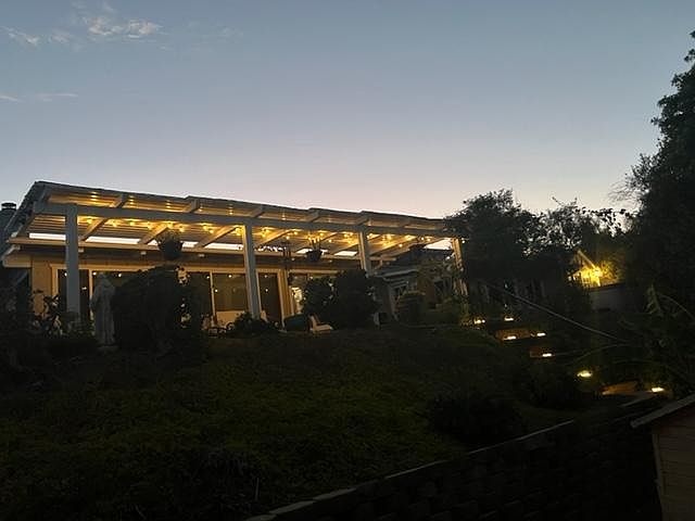 solar powered lights on covered patio and walkway leading to house from back
