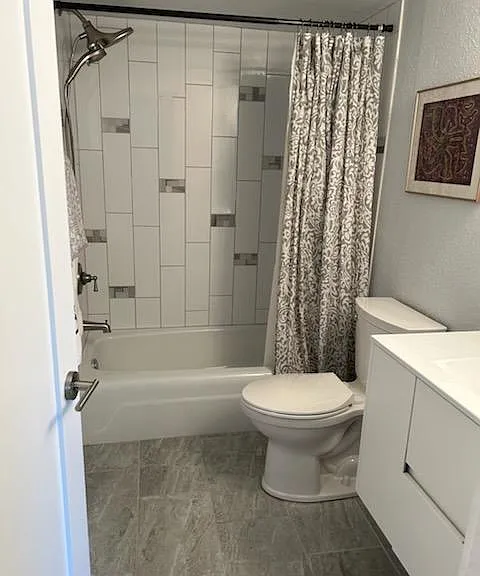 Custom tile and accents in both bathroom and accent tile in kitchen provides an easy flow