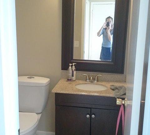 half bathroom downstairs between the kitchen and living area