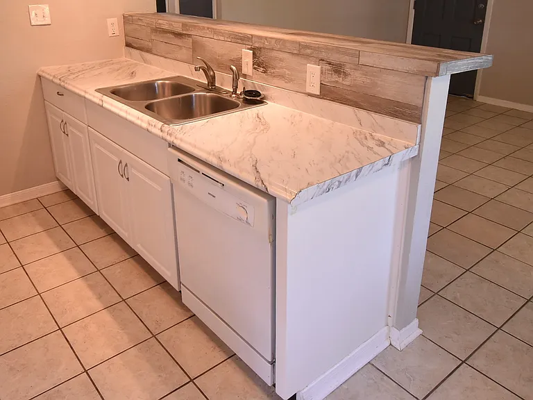 Kitchen features a double sink and plenty of counter space