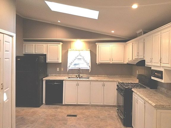 Kitchen - fridge, gas stove, dishwasher vaulted ceiling